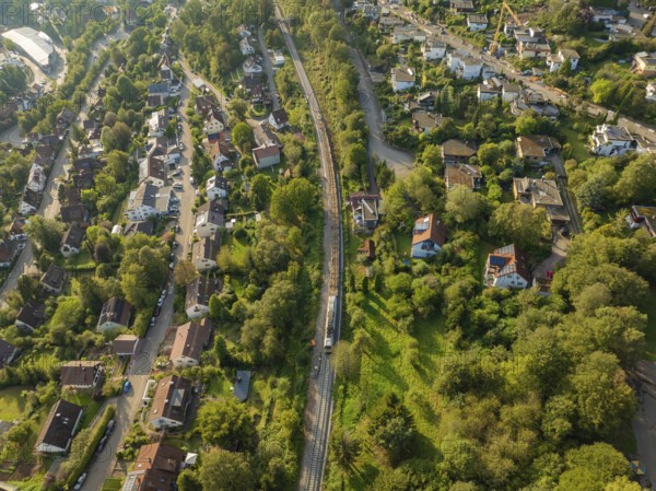 Rails and roads between densely overgrown residential areas, track construction, rail delivery for