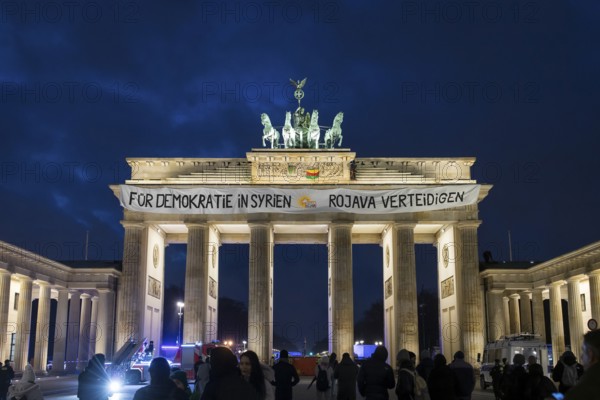 A banner For Democracy in Syria / Defend Rojava hangs at the Brandenburg Tor, Berlin, 16 December