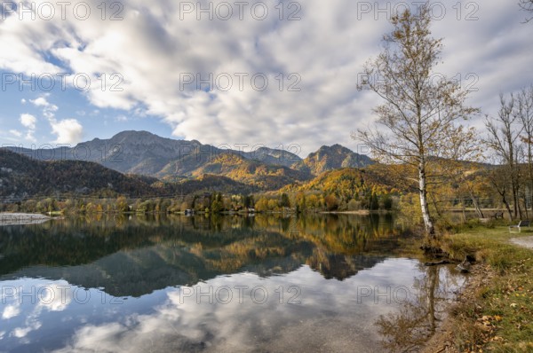 On the shore of Lake Lake Kochel with reflection, autumn landscape with mountain peaks Herzogstand
