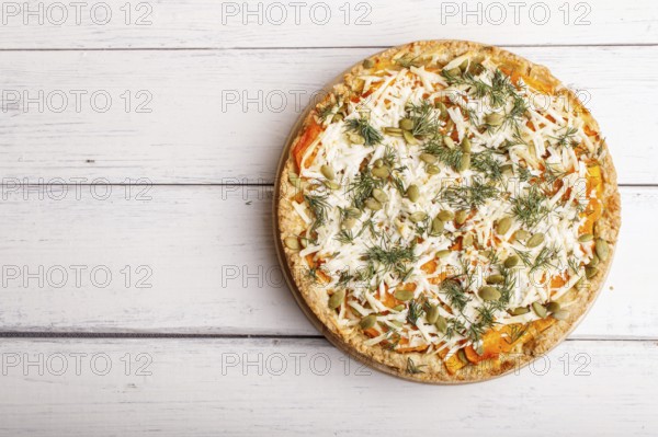 Sweet pumpkin pie with cheese and dill on white wooden background. top view. copy space