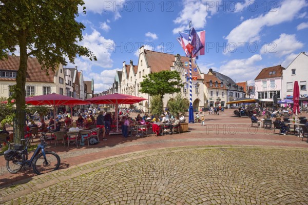 Market square with maypole, outdoor catering areas and the old town hall in the town centre of