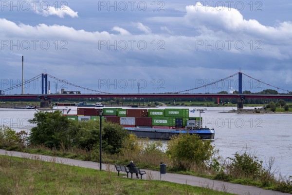 Cargo ship, loaded with containers, on the Rhine near Duisburg, the wheelhouse is raised to ensure