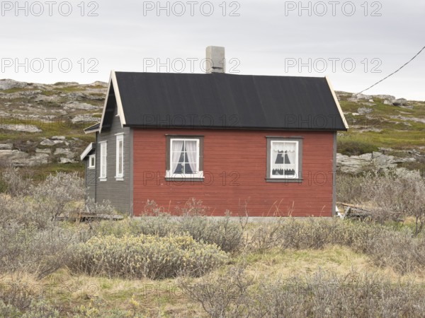 Holiday home on the shore of the Arctic Ocean, beside the town of Nesseby, May, Varangerfjord,