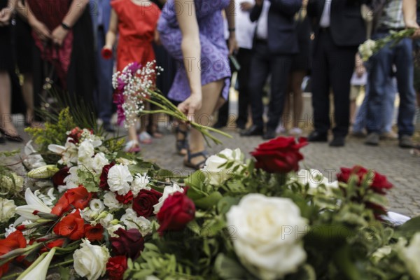 People lay flowers during a commemoration event on the anniversary of the German invasion of Poland