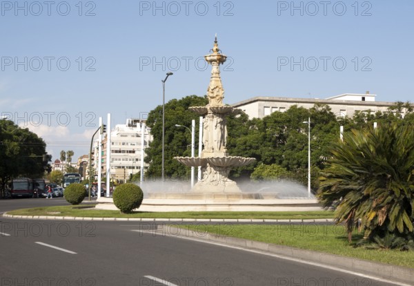 Fountain and sculpture in a road roundabout, Plaza de Don Juan de Austria, Seville, Spain, Europe