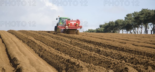Grimme 25 de-stoner machinery preparing soil for crop of potatoes in a field, Shottisham, Suffolk,