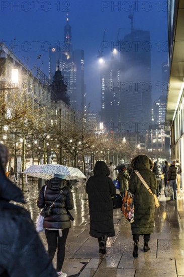 Rainy weather, freezing rain, pedestrian zone Zeil, shopping street, high-rise skyline in clouds,
