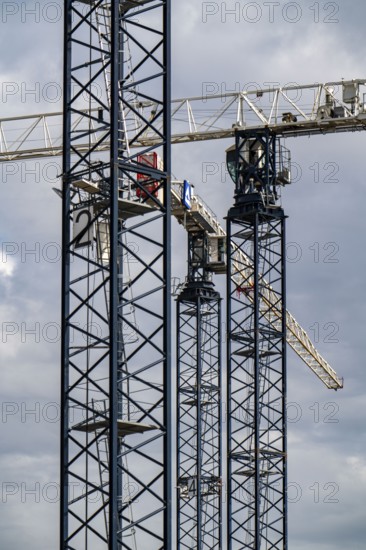Construction cranes on two large construction sites, construction of office buildings in