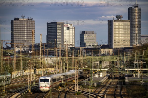 Train on the tracks west of Essen central station, skyline of the city centre, ICE train, North