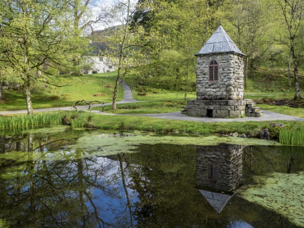 Springtime at the park of baroniet Rosendal, pond with tower, old castle, Rogaland, Norway, Europe