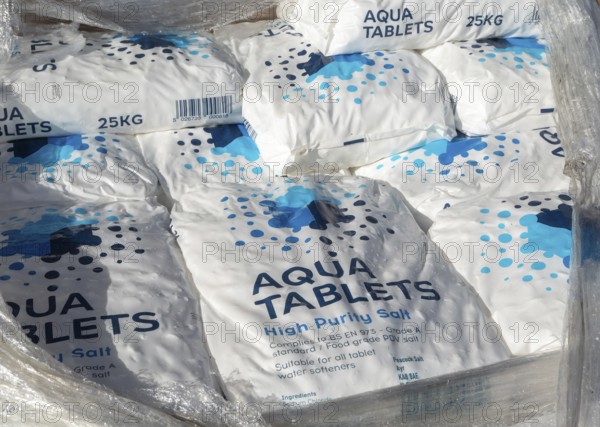 Piled 25kg bags of Aqua Tablets high purity salt tablets for water softeners, UK