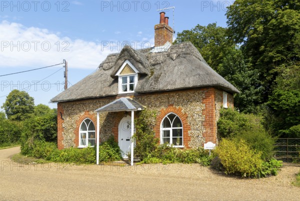 Flint and thatched historic country cottage former estate worker's home, Sutton, Suffolk, England,
