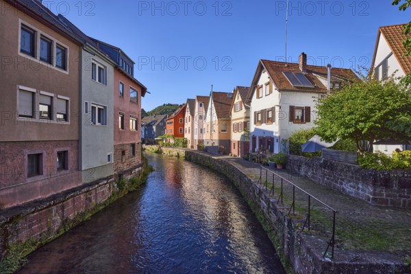 River Mud with houses in the evening sun in Amorbach, Lower Franconia, Miltenberg district,