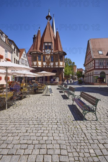 Market square with historic town hall, benches and outdoor area of a café in Michelstadt, Odenwald,