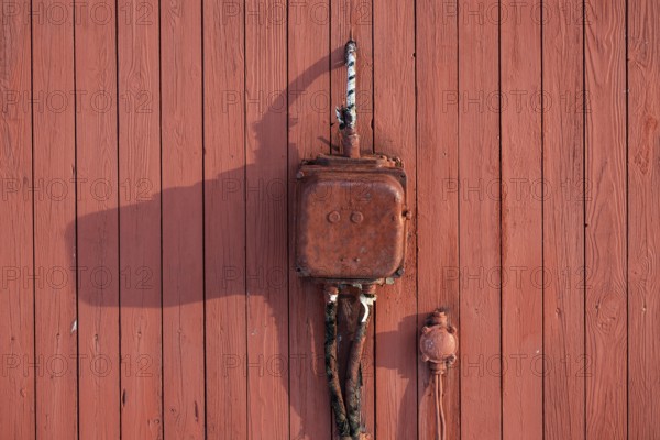 Old electrical junction box from Siemens, red painted wooden wall, Ny-Ålesund, Kongsfjord,