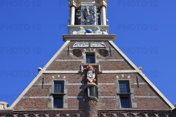 City coat of arms with unicorn and post horn on the historic Hoofdtoren defence defence tower in
