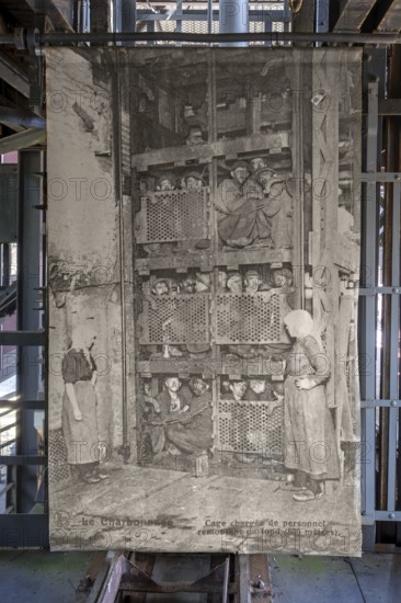 1920s old photograph showing coal miners in coal mining lift cage, elevator at Le Bois du Cazier
