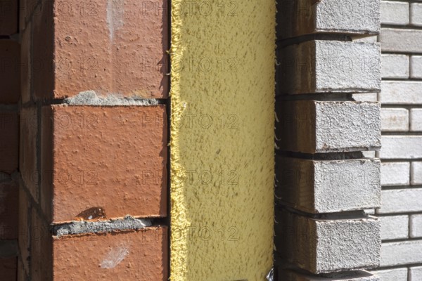 Close up of cavity wall insulation boards fitted in masonry cavities in newly built house used to