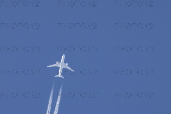 Boeing 787-8 Dreamliner jet passenger aircraft of Aeromexico flying in a blue sky with a vapor