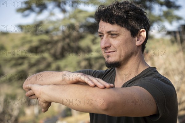A man practicing martial arts, his posture reflecting determination and serenity as he connects
