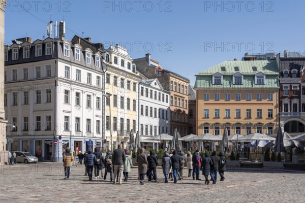 Tourists walk across the cathedral square in the Latvian capital Riga, Latvia, Europe