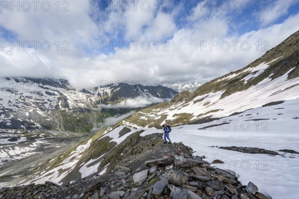 Mountaineer on hiking trail with snow, mountain landscape with summit Hoher Weißzint and