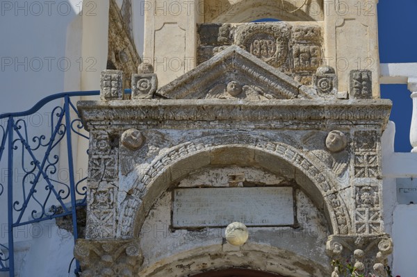 Detailed view of an old stone architecture with engraved decorations and an inscription, Platia and