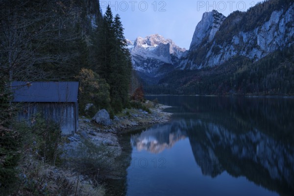 The Vordere Gosausee lake in autumn with a view of the Dachstein mountain range. The Gosaukamm on