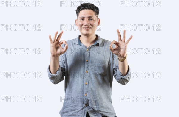 Interpreter person gesturing OK in sign language. Smiling young man gesturing APPROVED in sign