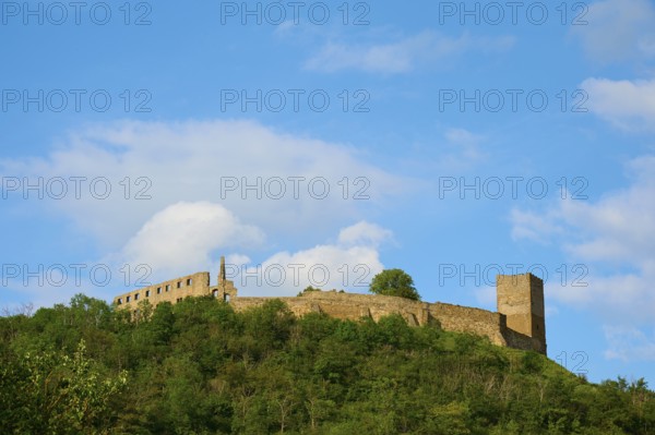 A castle ruin on a wooded hill under a blue sky with clouds, Gleichen Castle or Wanderslebener