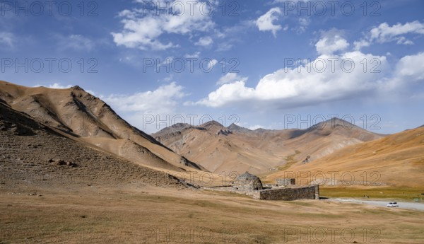 Historic caravanserai Tash Rabat from the 15th century, with yellow hills, Atbashy district in the