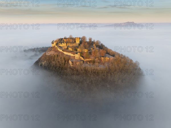 Aerial view of the Hegau volcano Hohentwiel with the upper fortress ruins illuminated by the rising