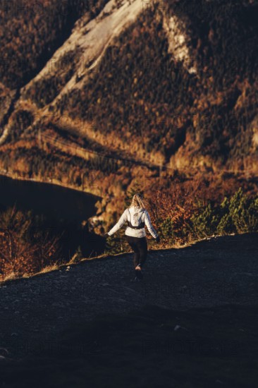 Trail running in autumn on the Jochberg on Lake Walchensee against the wonderful backdrop of the