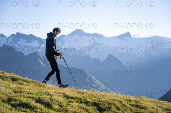 Hiker enjoying the mountain panorama in the morning, Venediger group, behind Dreiherrenkopf,