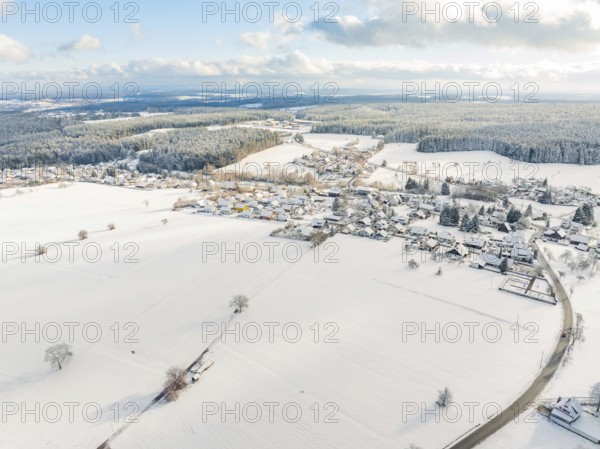 Village and fields under snow, wide winter landscape with clear view and cold atmosphere,