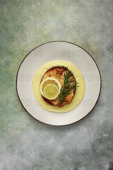 Salmon steak, fried, mashed potatoes, top view, rosemary, lemon and lime, homemade, one serving, no