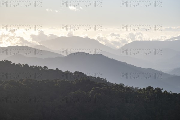 View of hills with cloud forest, in the evening light, Dramatic clouds between the mountains,