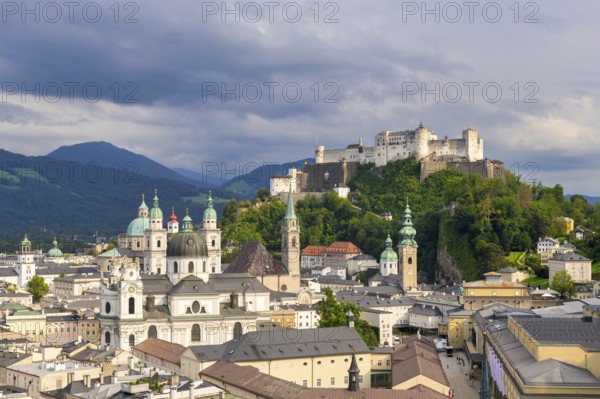 Salzburg's historic city centre with Hohensalzburg Fortress, surrounded by cloudy sky, Salzburg,