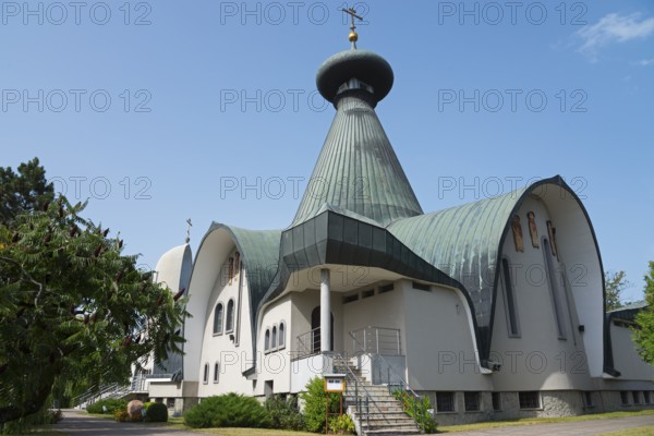 Modern church with green roof and cross under a blue sky, Holy Trinity Cathedral, Hajnówka,