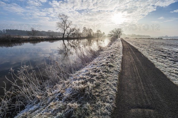 River Aller on a frozen winter day, hiking and cycling path along the river, between Celle and