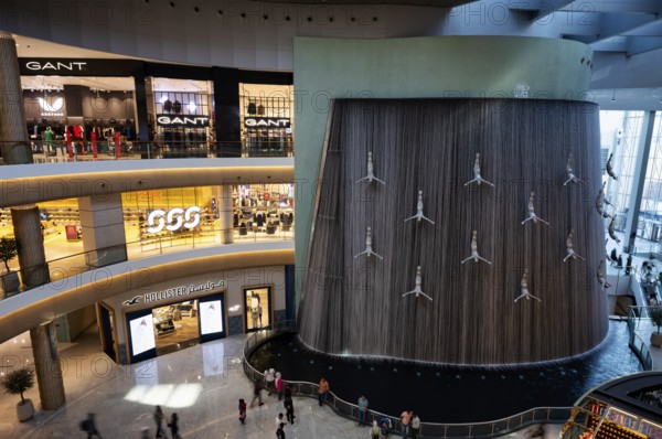 Interior view, The Waterfall, artificial indoor waterfall with life-size jumper sculptures,