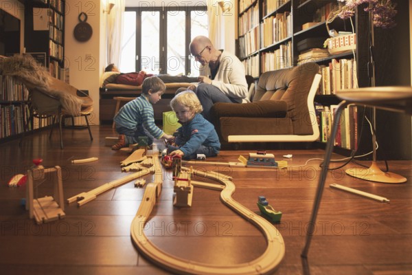 Playing children, two and four years old and their grandfather, in the family, Bonn, 24.12.2023. In