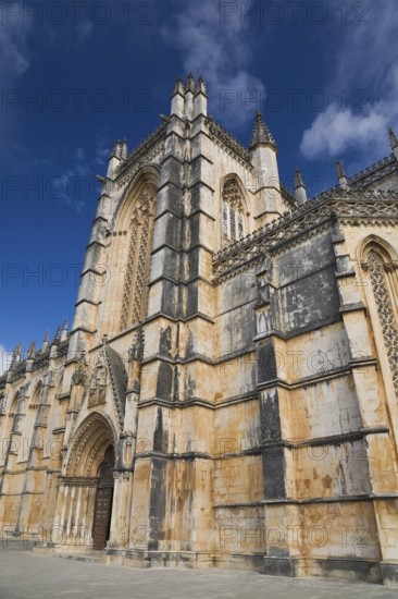 14th century built Santa Maria da Vitoria Monastery with arched entrance door, Batalha, Portugal,