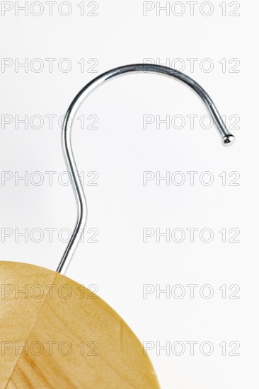 Close-up of the hook of a wooden coat hanger, white background