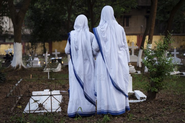 Nuns offer prayers on the grave during the All souls day observation, in Guwahati, India on 2