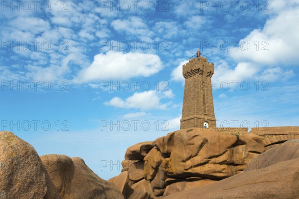 Lighthouse resting majestically on massive rocks under a clear sky, Phare de Men Ruz, Ploumanac'h,