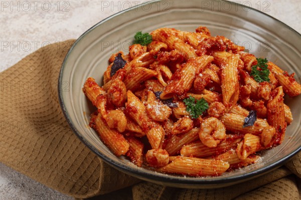 Penne pasta, with shrimp in tomato sauce, close-up, no people