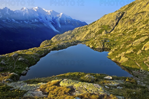 Mountain lake Lacs des Chéserys in the Aiguilles Rouges nature reserve, behind Mont Blanc massif,