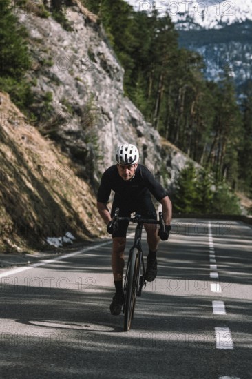 Road bike rider in spring between Lechtal and Tannheimer Tal in front of picturesque scenery of the