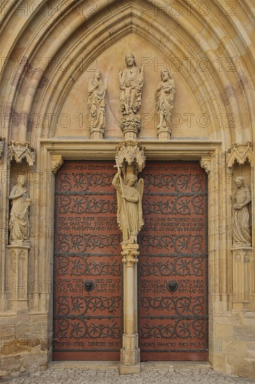 Sculptures on the Virgin Mary portal with tympanum and Archangel Michael, Gothic church portal,